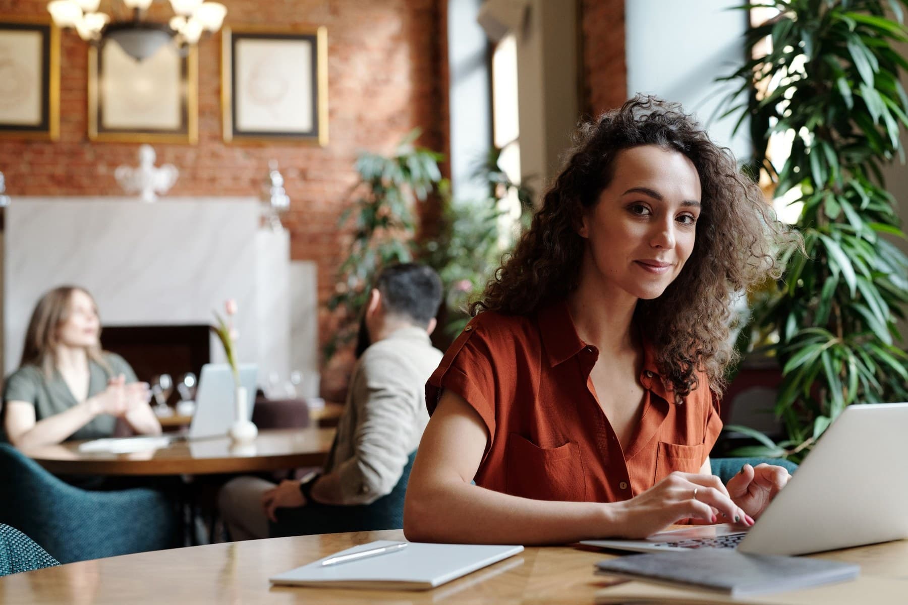 A person using a laptop in a welcoming cafe