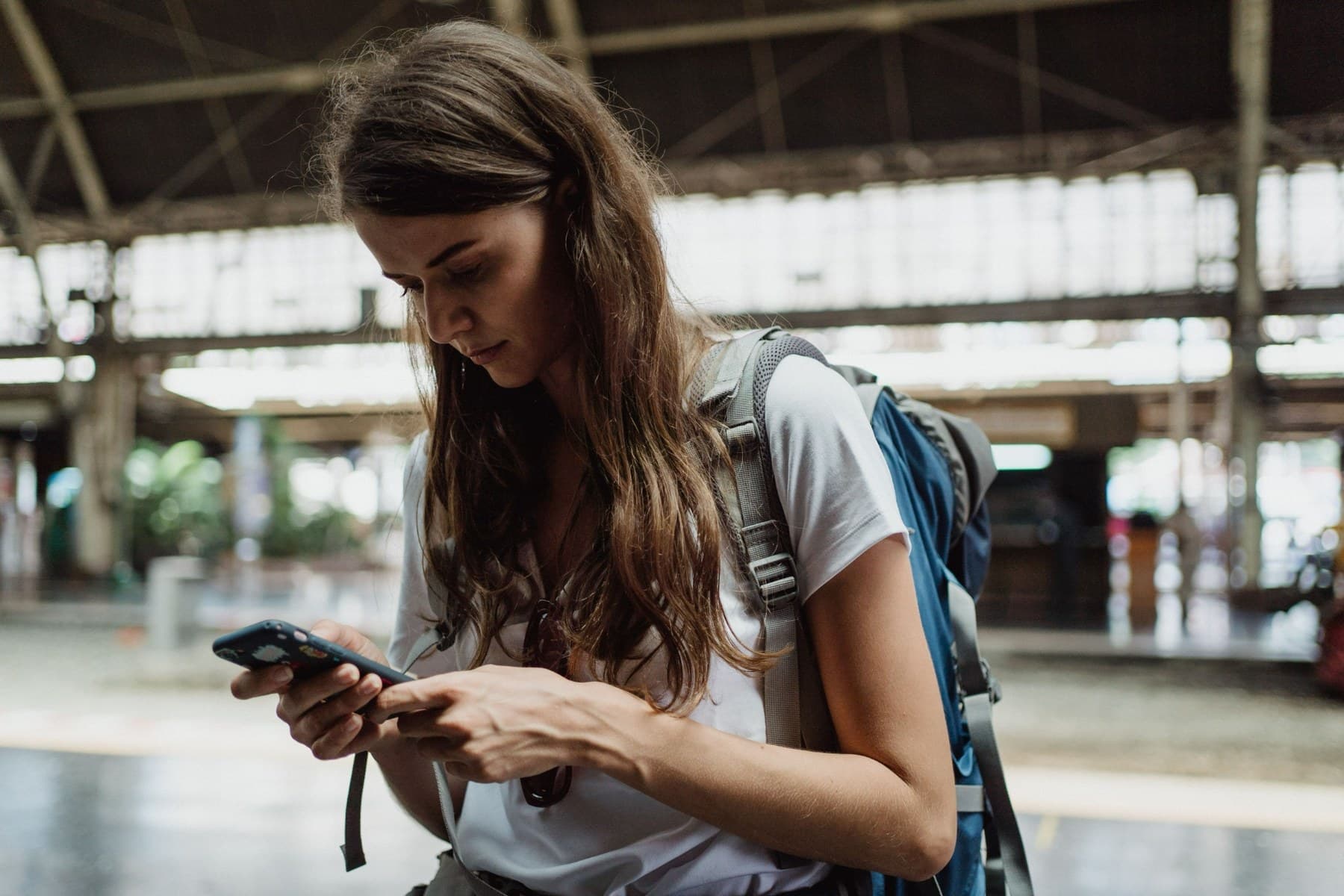 Traveler using a cellphone while on the go
