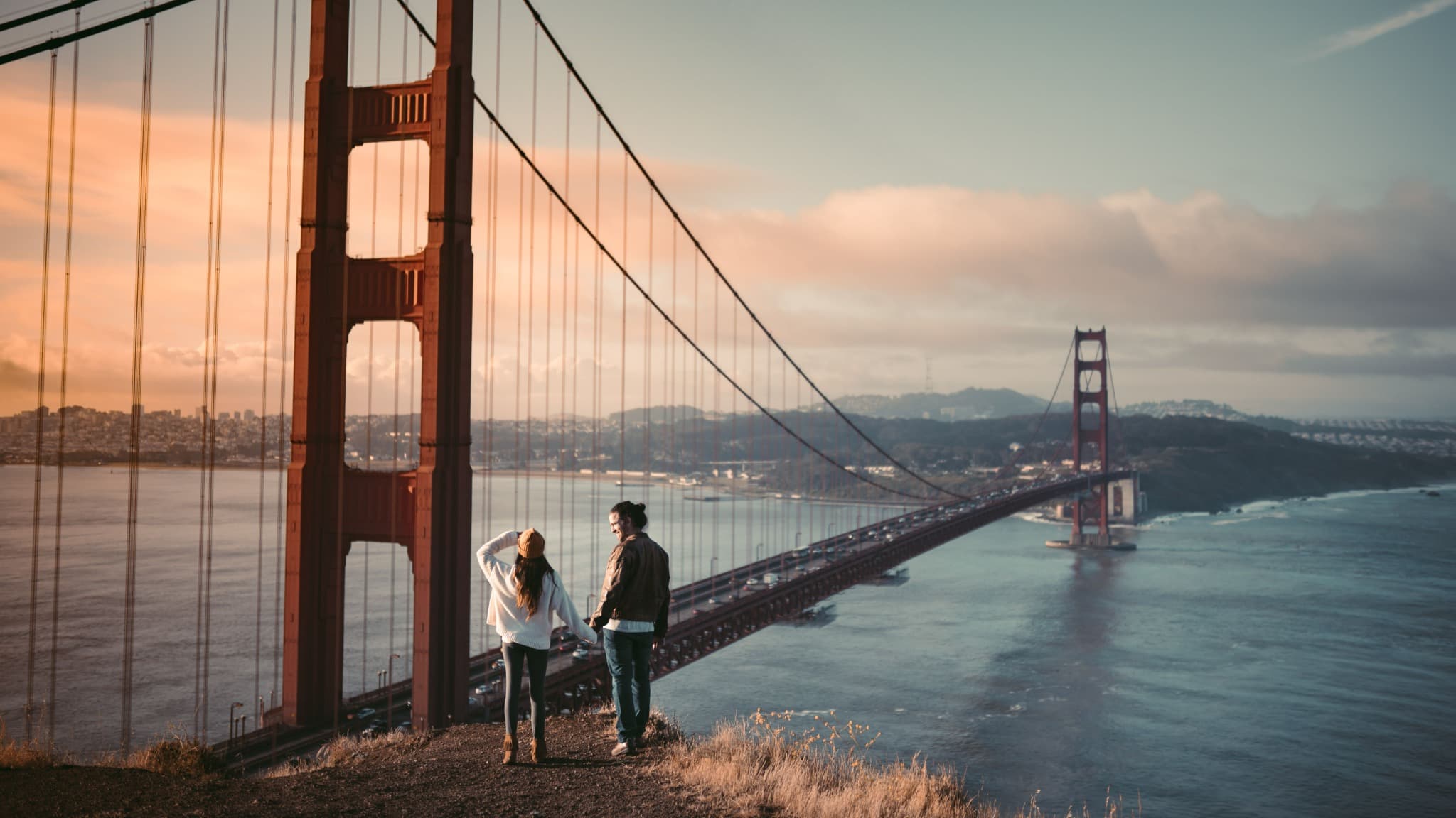 A couple overlooking the Golden Gate Bridge